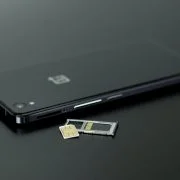black smartphone on black table top