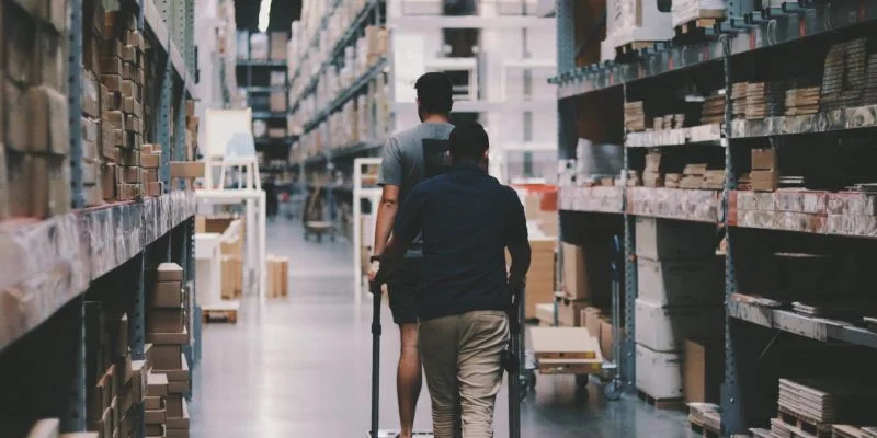 men going around a warehouse