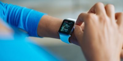 person in blue long sleeve shirt using smart watch