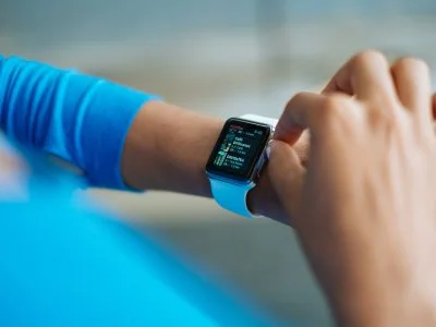 person in blue long sleeve shirt using smart watch